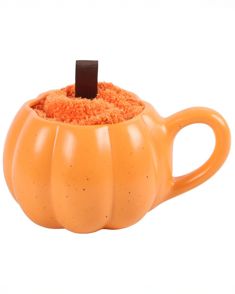 Side view of the ceramic pumpkin-shaped mug and socks set, with a cosy fleece backdrop. A seasonal gift set from Rebel Romance.