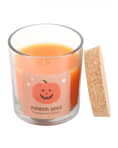 The Peekaboo Pumpkin Spice Candle inside a glass jar, with a vibrant orange wax and a cork lid for sealing in the fragrance when not in use.