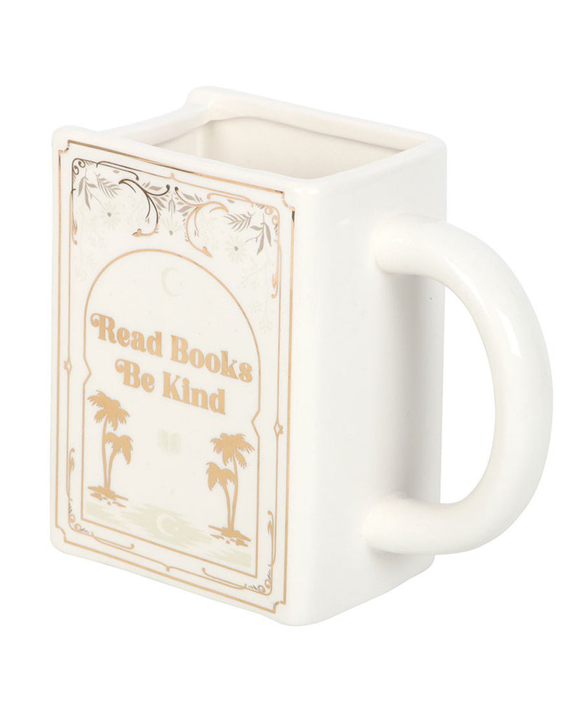 Close-up of the Rebel Romance Read Books Be Kind white ceramic mug, designed in the shape of a book with gold lettering and palm tree illustrations. A whimsical and unique gift for bookworms, tea lovers, and those who adore literary-themed homeware.