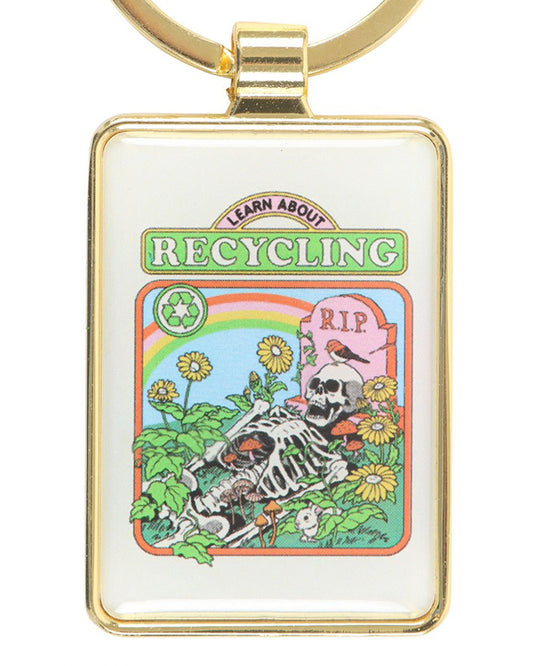 Rectangular enamel keyring with a gold frame from Rebel Romance featuring Steven Rhodes’ “Learn About Recycling” design. The artwork shows a skeleton among sunflowers and mushrooms beneath a rainbow with a gravestone marked “RIP”. A quirky eco-gothic gift blending humour, retro style and sustainability.