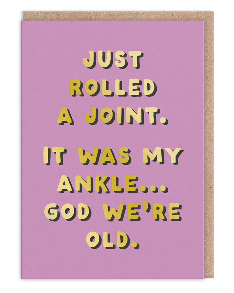 Funny purple greeting card with bold gold foil text reading Just rolled a joint It was my ankle God we are old Comes with a brown kraft envelope A hilarious birthday card by Ohh Deer for friends and adults with a cheeky sense of humour
