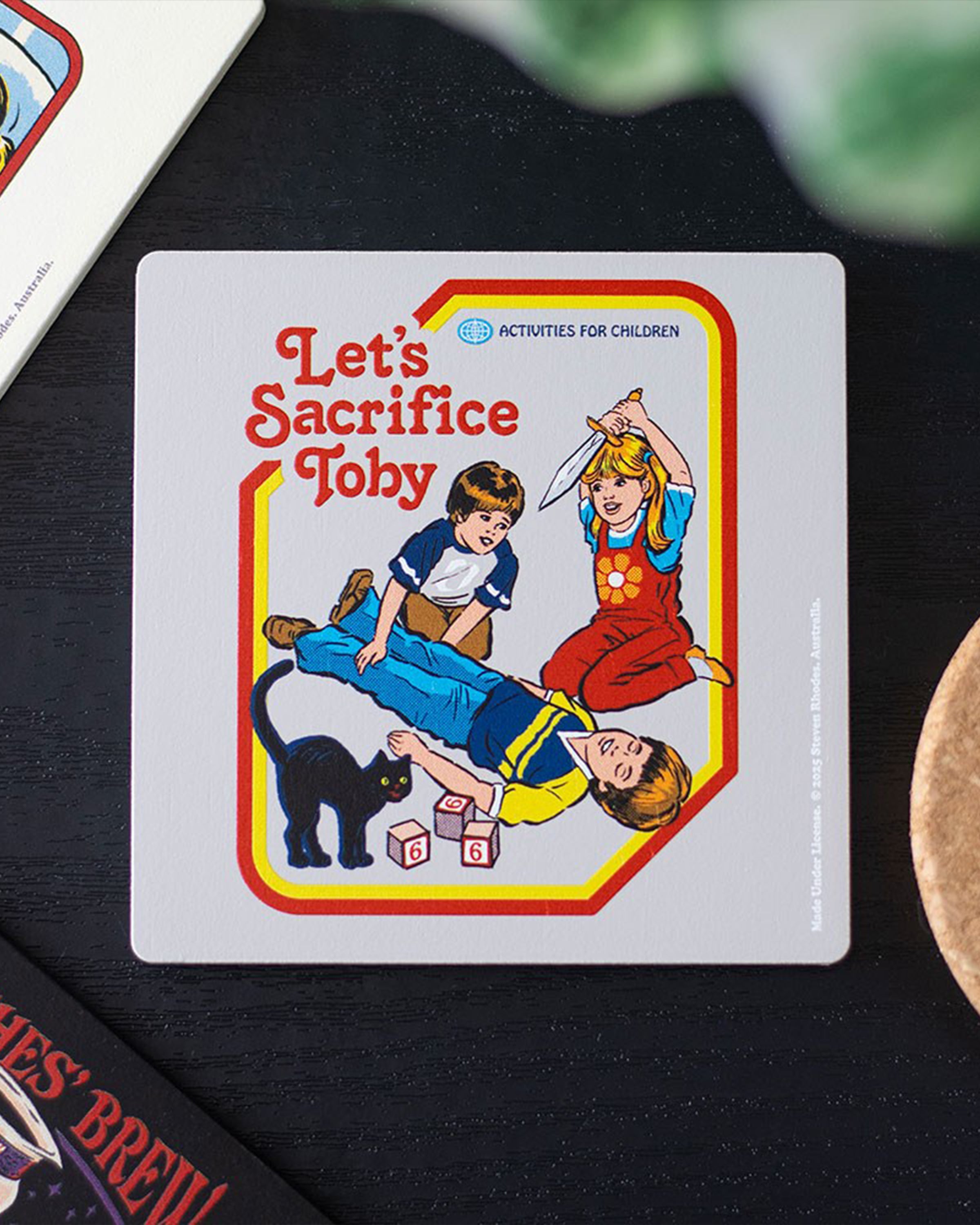 Steven Rhodes Let’s Sacrifice Toby Coaster styled on a dark table, available at Rebel Romance UK. The alternative retro design makes it perfect gothic homeware for millennials who love quirky humour, dark aesthetics, and nostalgic parody gifts.