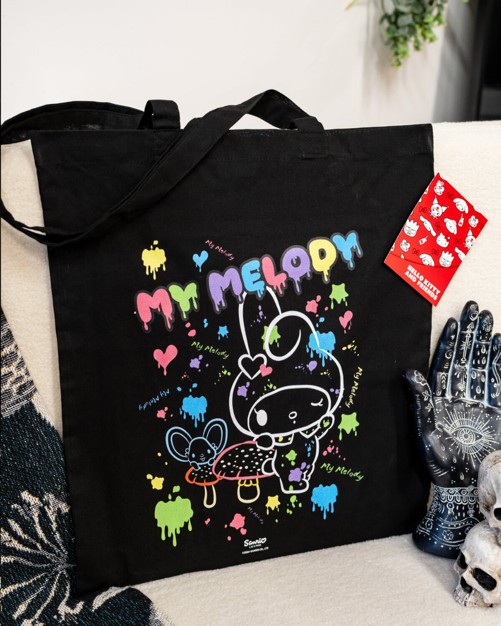 my melody Sanrio official tote bag in black with a cute white outline of My Melody with coloured paint splatters