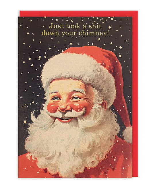 Funny retro-style Christmas card featuring a smiling vintage Santa Claus illustration with falling snow and bold gold foil text that reads "Just took a shit down your chimney!" Designed by Ohh Deer. Sold by Rebel Romance, a UK-based alternative lifestyle brand known for quirky, rebellious stationery and gifts for millennials.