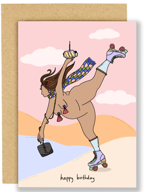 A playful birthday card featuring a roller‑skating woman wearing accessories and nipple tassels, holding a birthday cake with a candle, against a pastel landscape background. The card reads “happy birthday” and comes with a brown Kraft envelope.