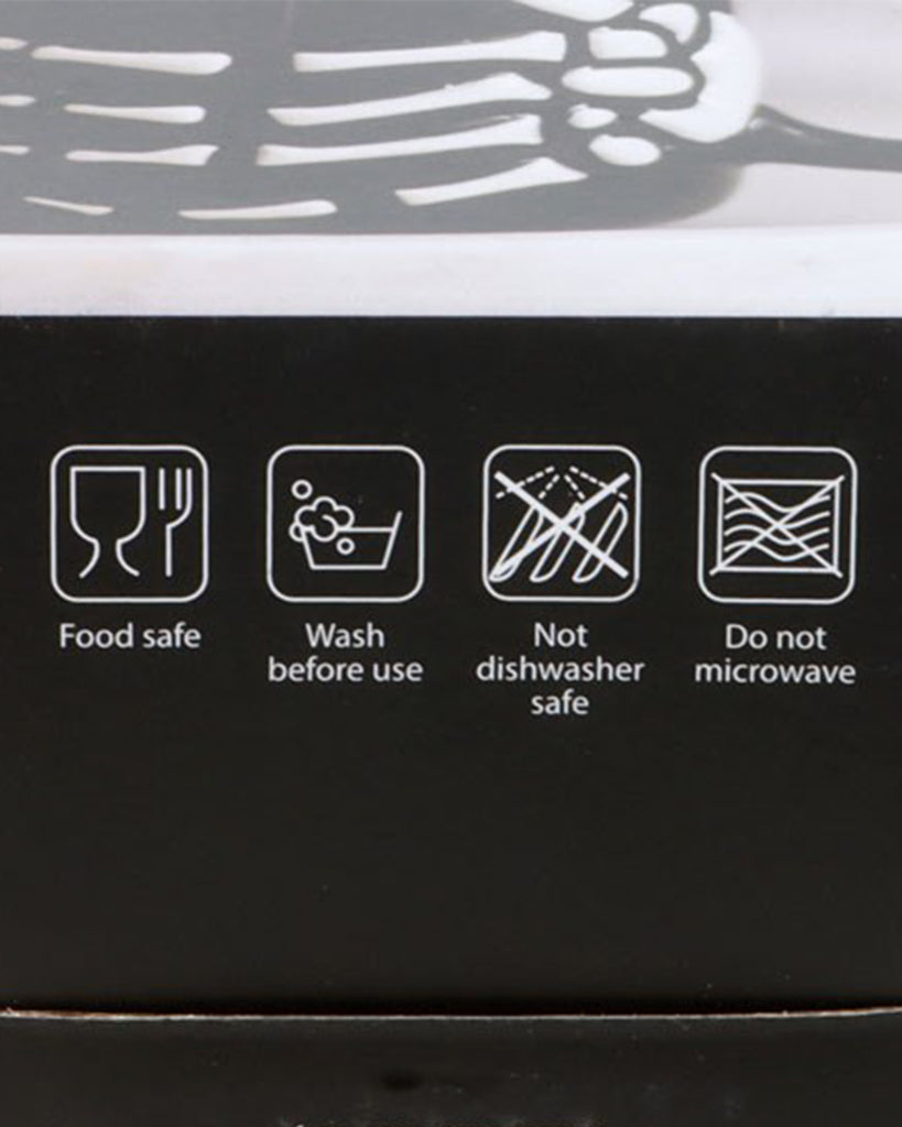 Product box icons showing the skeleton hand mug is food safe, wash before use, not dishwasher safe, and not microwave safe.