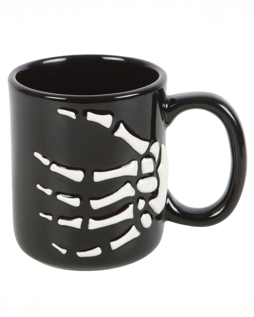 Front view of the Skeleton Hand Mug showing the full wraparound bone detail of a white skeleton hand gripping the side.