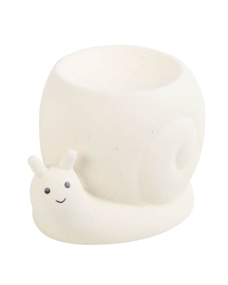 A side-angle view of the Rebel Romance ceramic snail oil burner, showcasing its smooth, off-white design with a coiled shell. The small oil dish sits neatly on top, ready for wax melts or essential oils. This adorable, nature-inspired home accessory adds a whimsical and cosy touch to any alternative or boho-inspired space.