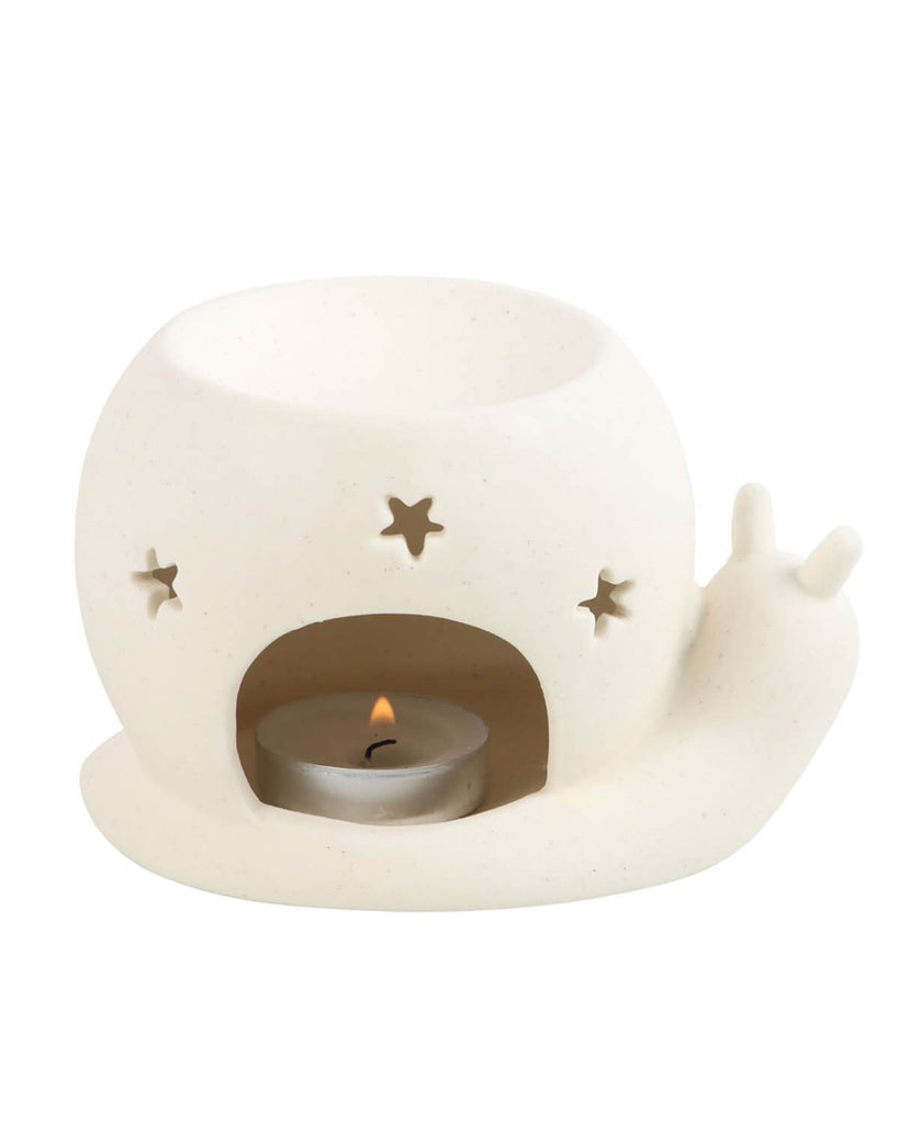 A white ceramic snail oil burner with a minimalist, whimsical design. The tea light is placed inside a cut-out section at the base, with star-shaped holes on the shell allowing the warm glow to shine through. This alternative home decor piece from Rebel Romance adds a cosy and enchanting vibe to any space, perfect for lovers of gothic, witchy, and retro aesthetics.