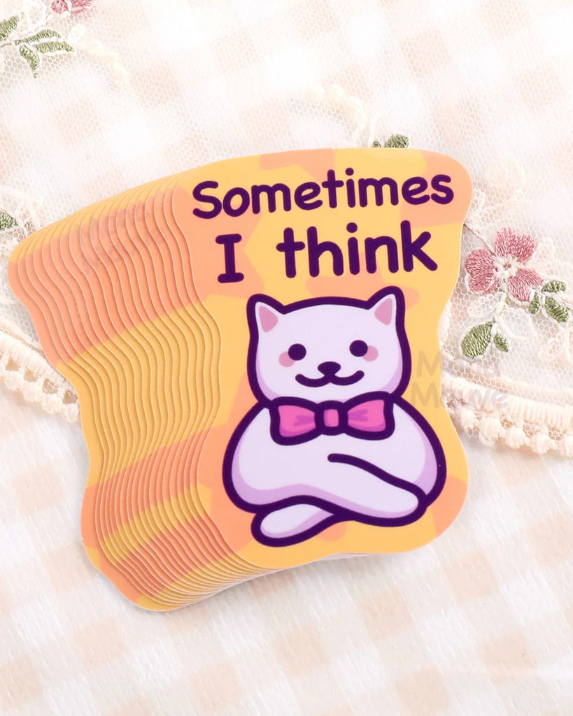 Stack of Rebel Romance funny cat meme vinyl stickers by Mona Mauve, featuring a white cartoon cat with a pink bow tie and the text “Sometimes I think” on a yellow-orange camo-style background. Waterproof and durable with a glossy finish, ideal for notebooks, water bottles, laptops, or as a quirky gift. Displayed on soft lace fabric with floral detail, perfect for millennials who love humour, cats, and alternative stationery with personality.