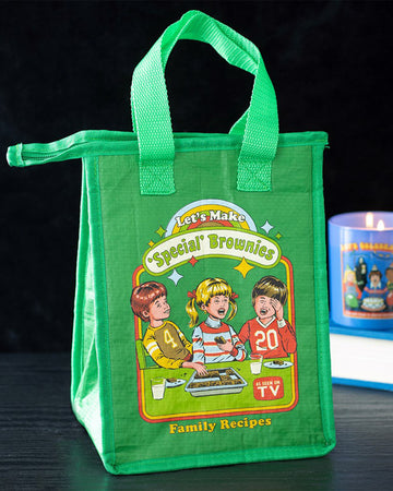 Rebel Romance insulated lunch bag featuring Steven Rhodes’ “Let’s Make Special Brownies” retro design. Made from recycled plastic with foil lining and zip closure, this quirky green bag is perfect for keeping food fresh while adding humour to lunchtime.