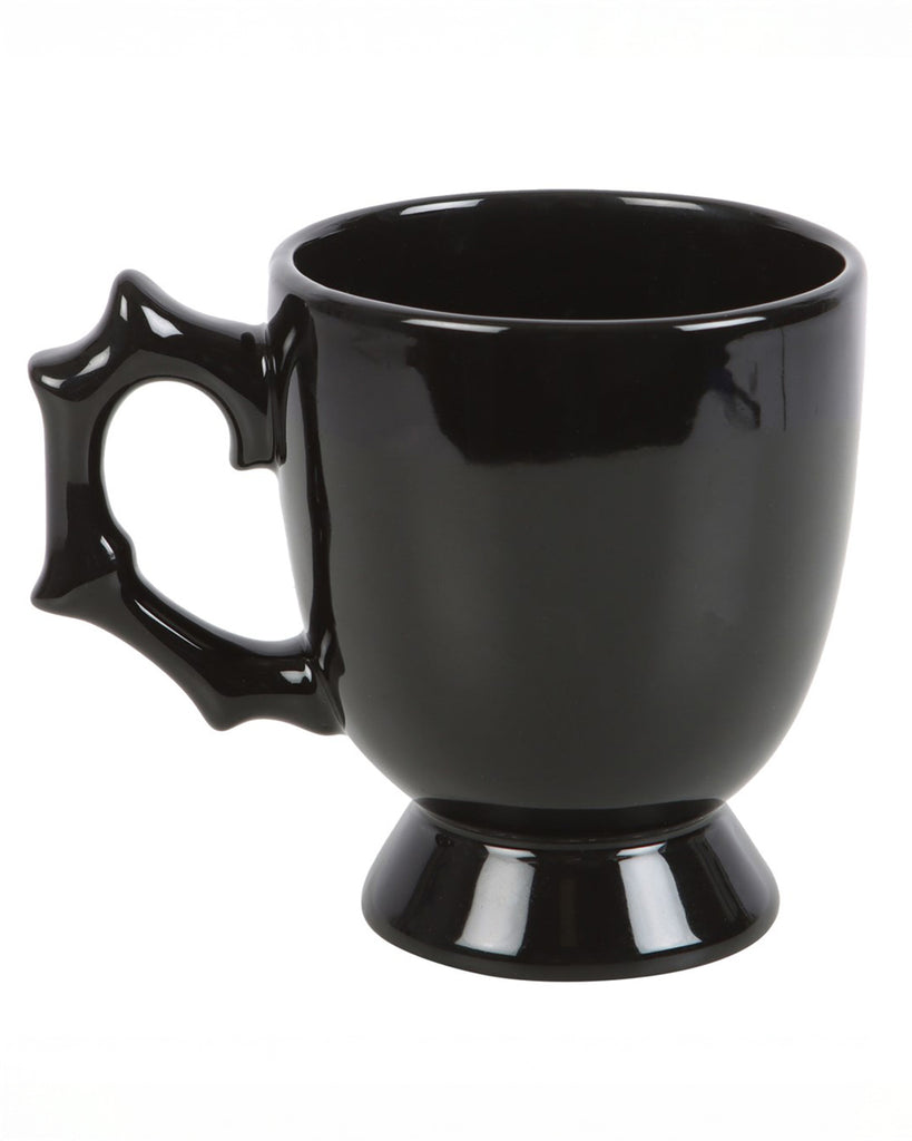 Product-only shot of the plain black teacup showing the sculpted handle and pedestal base.