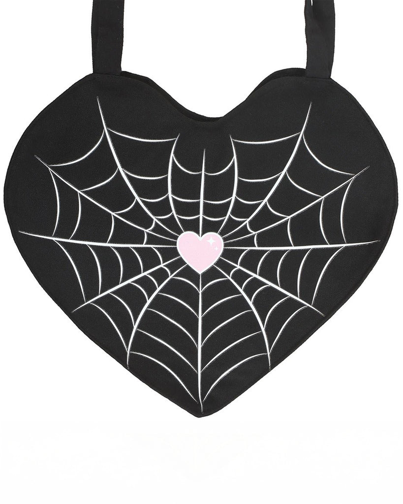 Heart-shaped black tote bag with a white spiderweb print and pastel pink heart in the centre. Designed by Rebel Romance, a UK brand specialising in gothic and alternative fashion accessories.