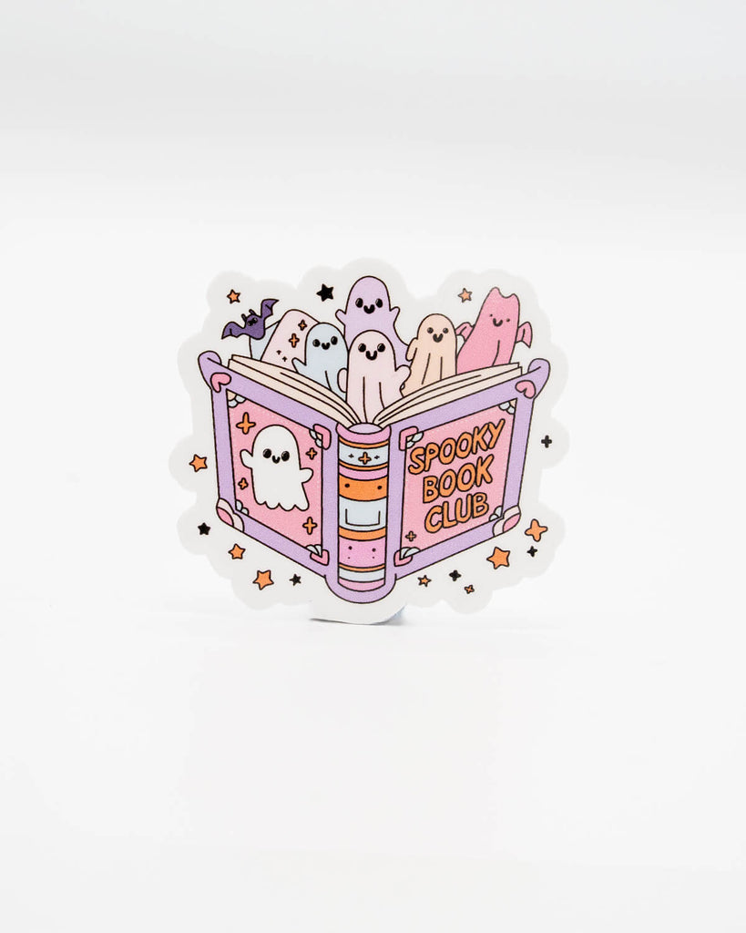 Cute die-cut vinyl sticker featuring pastel-coloured ghosts popping out of a pink and purple book labelled “Spooky Book Club,” surrounded by stars and sparkles. A fun Halloween-themed design perfect for readers and ghost lovers. Created by Rebel Romance, a small UK brand celebrating alternative fashion, spooky aesthetics, and quirky millennial-friendly gifts.