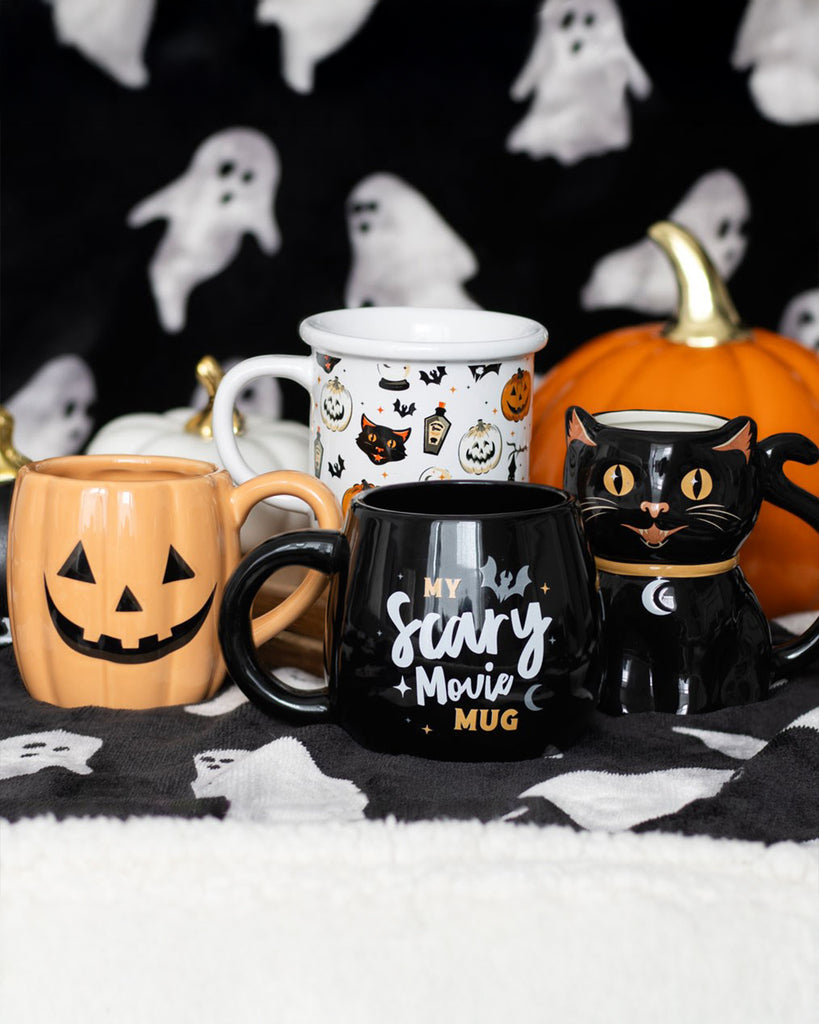 A collection of Halloween-themed mugs from Rebel Romance, including a white ceramic mug featuring black cats, pumpkins, bats, and potion bottles in a vintage-inspired print. Perfect for autumn vibes and spooky season.