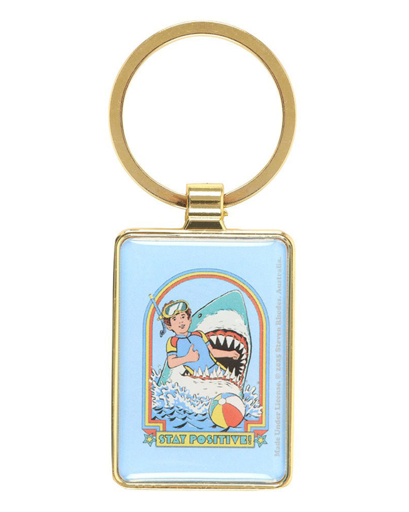 Front view of the Rebel Romance Steven Rhodes Stay Positive enamel keyring, showing snorkeller mid-shark attack with rainbow frame and retro style art. A fun, officially licensed Steven Rhodes design for alternative gift collectors.