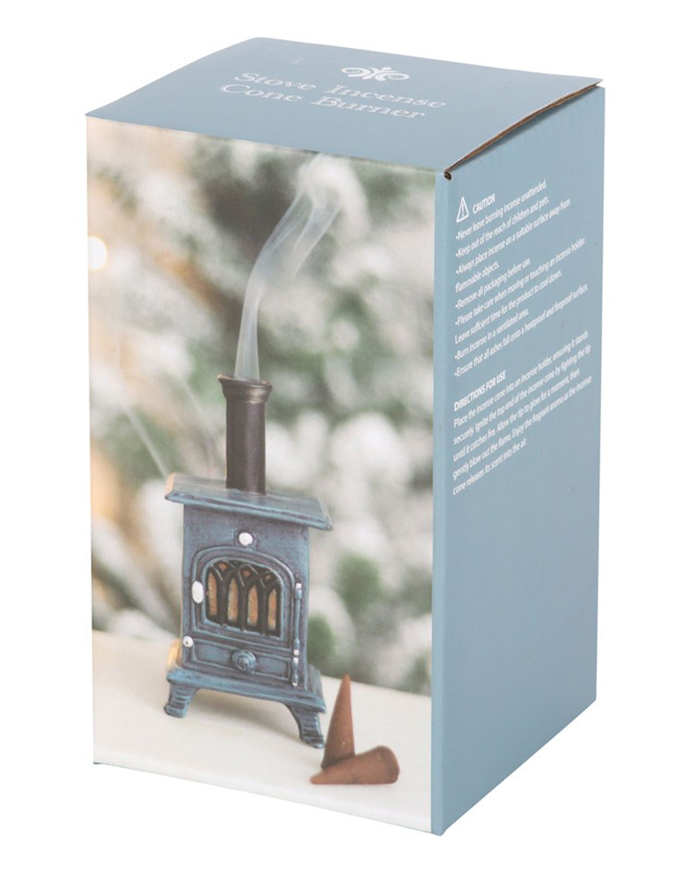 Packaging of the Rebel Romance Stove Shaped Incense Cone Burner showing the mini stove burner with smoke curling from the chimney, placed beside two incense cones. A cosy winter scene in the background enhances its rustic charm.
