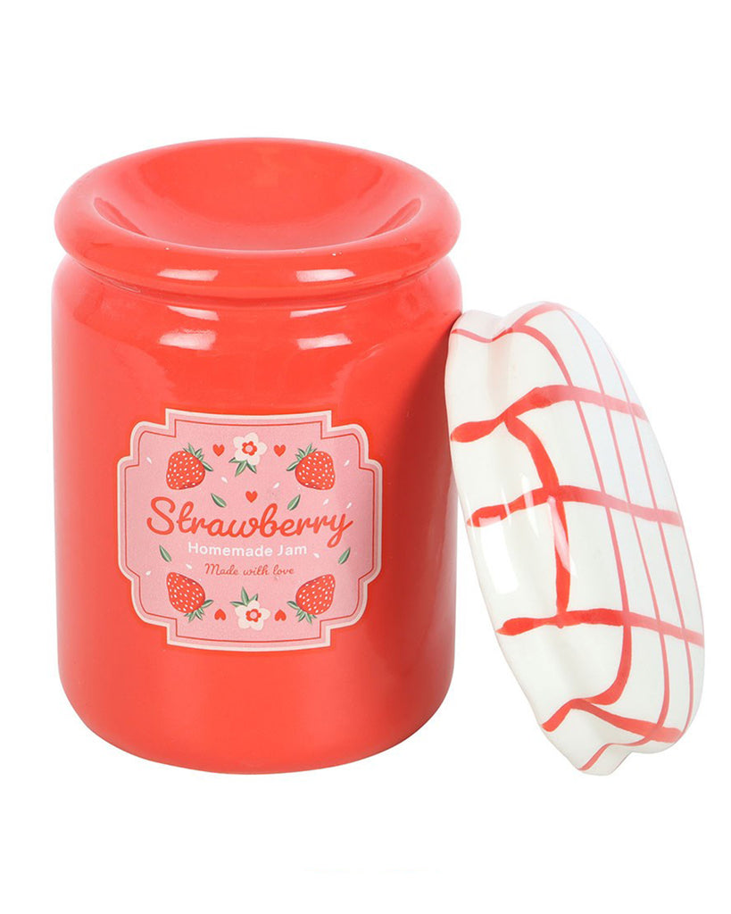 Strawberry jam jar oil burner with removable lid: The red ceramic burner is displayed with its white and red checked lid removed, revealing the dish inside for wax melts or essential oils. The charming vintage-inspired label reads "Strawberry Homemade Jam."