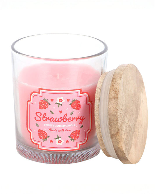 Close-up of Rebel Romance Strawberry Scented Candle with pink wax in a glass jar, shown with its natural wooden lid. Fun fruity gift from an ethical UK small business for millennials.