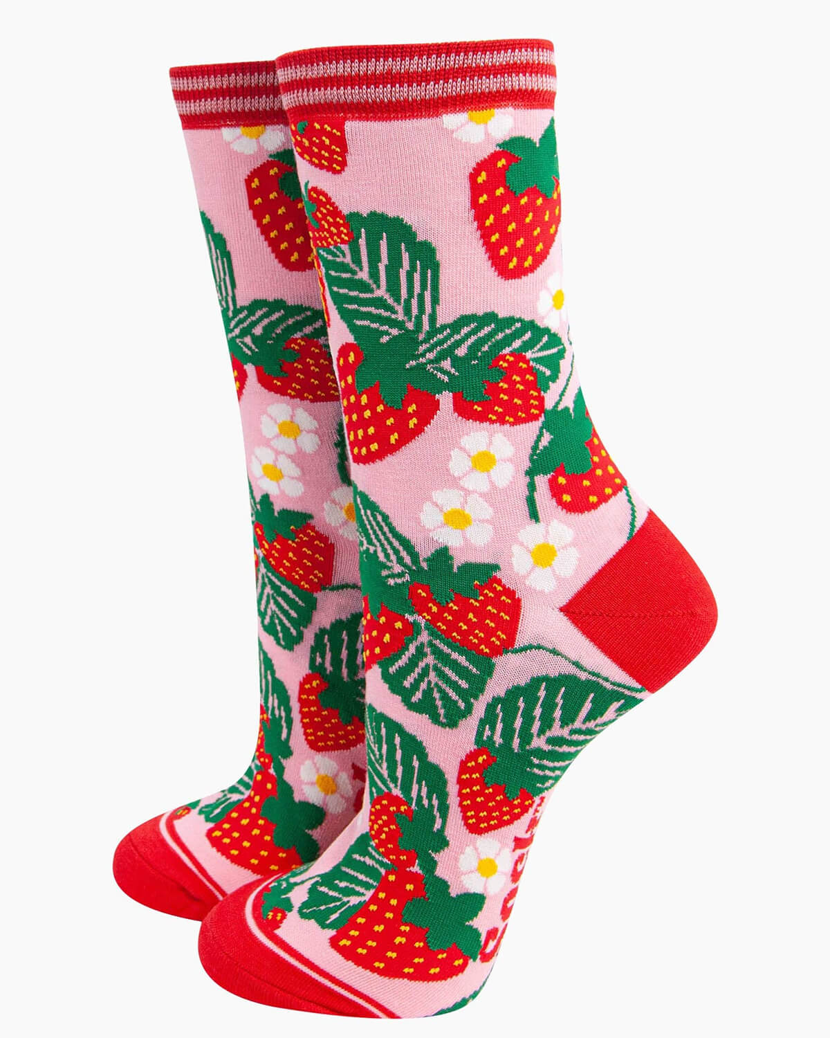 (Socks Standing Up): A pair of pink bamboo socks with a strawberry print displayed upright, featuring bright red strawberries, lush green leaves, and delicate white flowers. The striped cuff, red heel, and red toe complete the summery design.