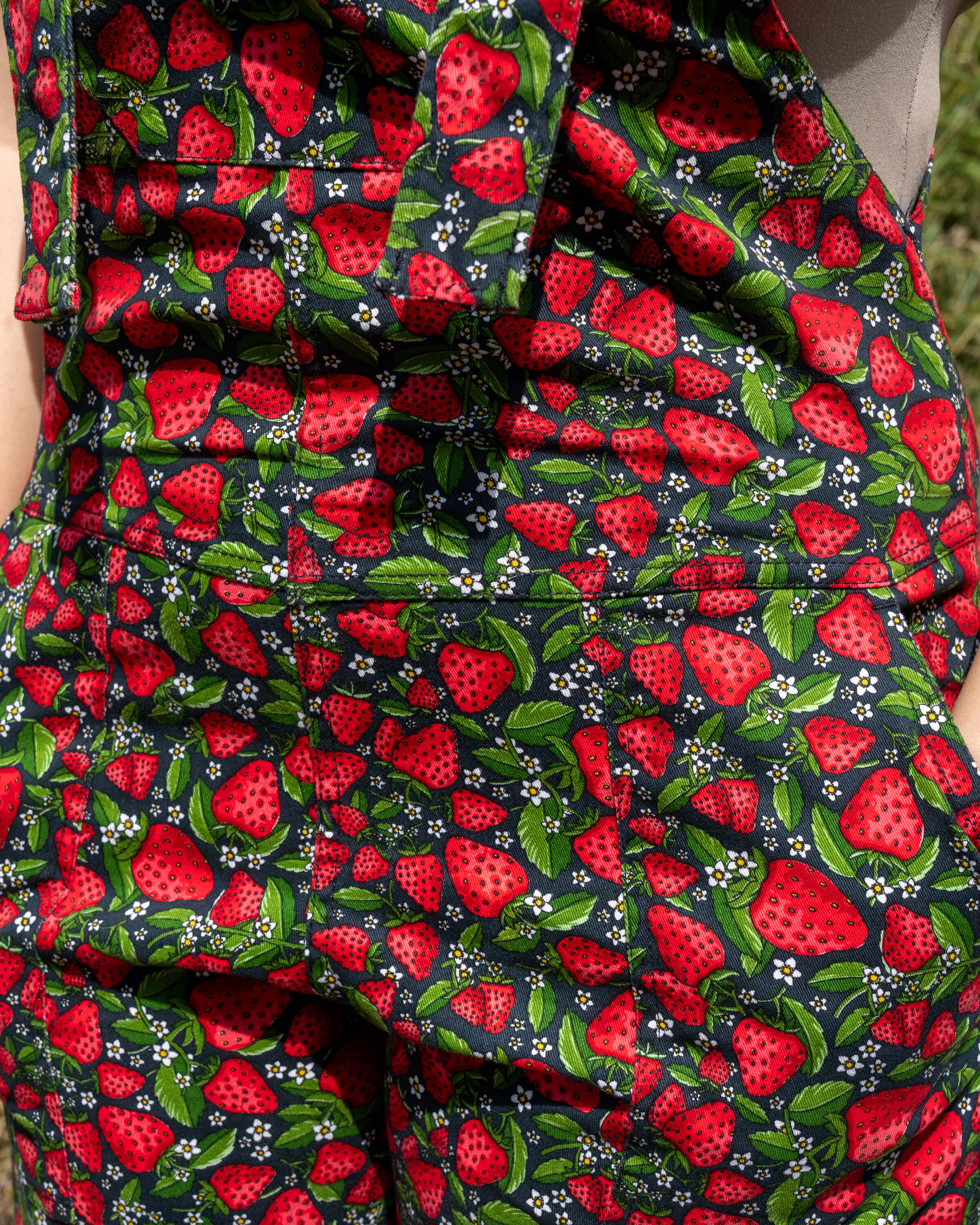 Detail shot of the Strawberry Field dungarees by Rebel Romance, focusing on the rolled hems paired with chunky black lace-up boots for a statement alt style.