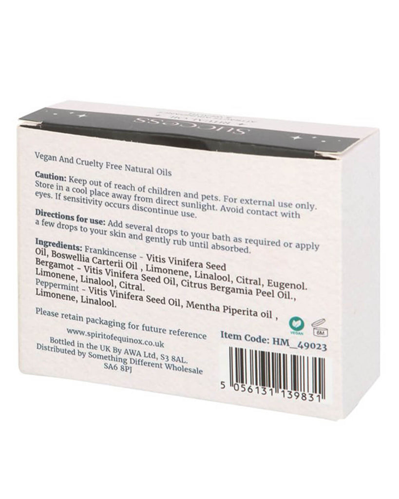  Back of the Success Ritual essential oils box displaying ingredients, usage directions, and vegan certification. The text is printed in black on a white background with decorative elements.