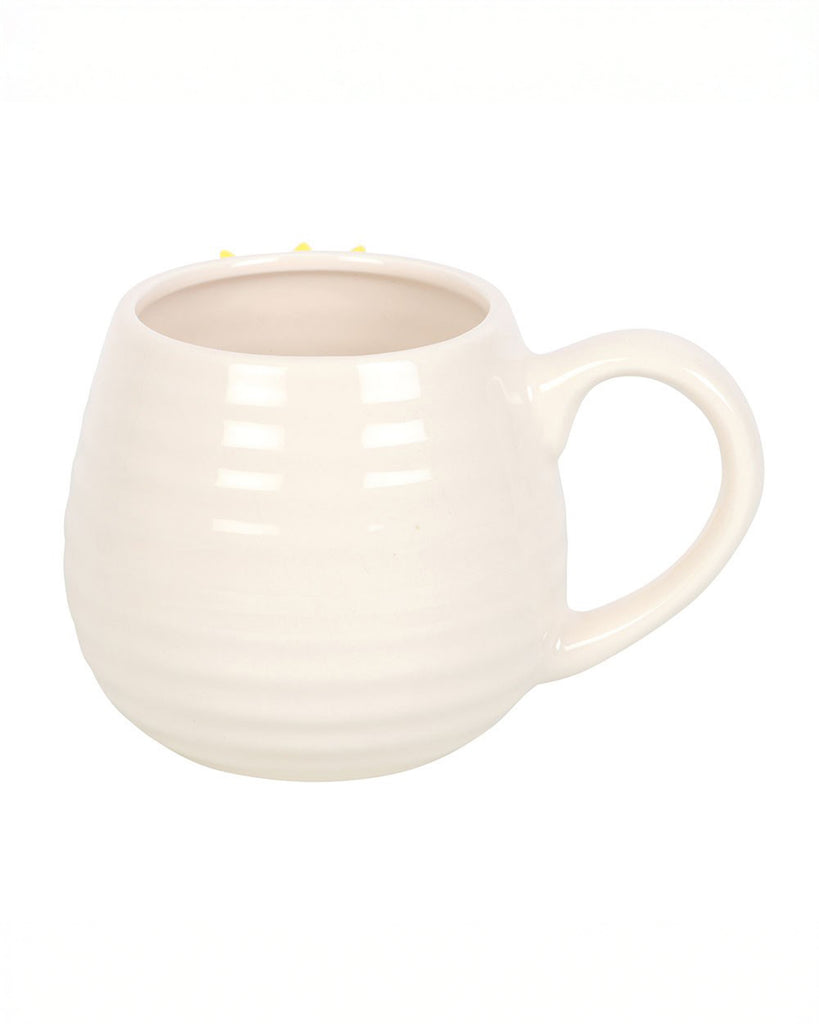 Side view of the Rebel Romance Hello Sunshine rounded ceramic mug without decorations visible, showing its cream ribbed design and curved handle, ready to brighten your morning coffee routine.