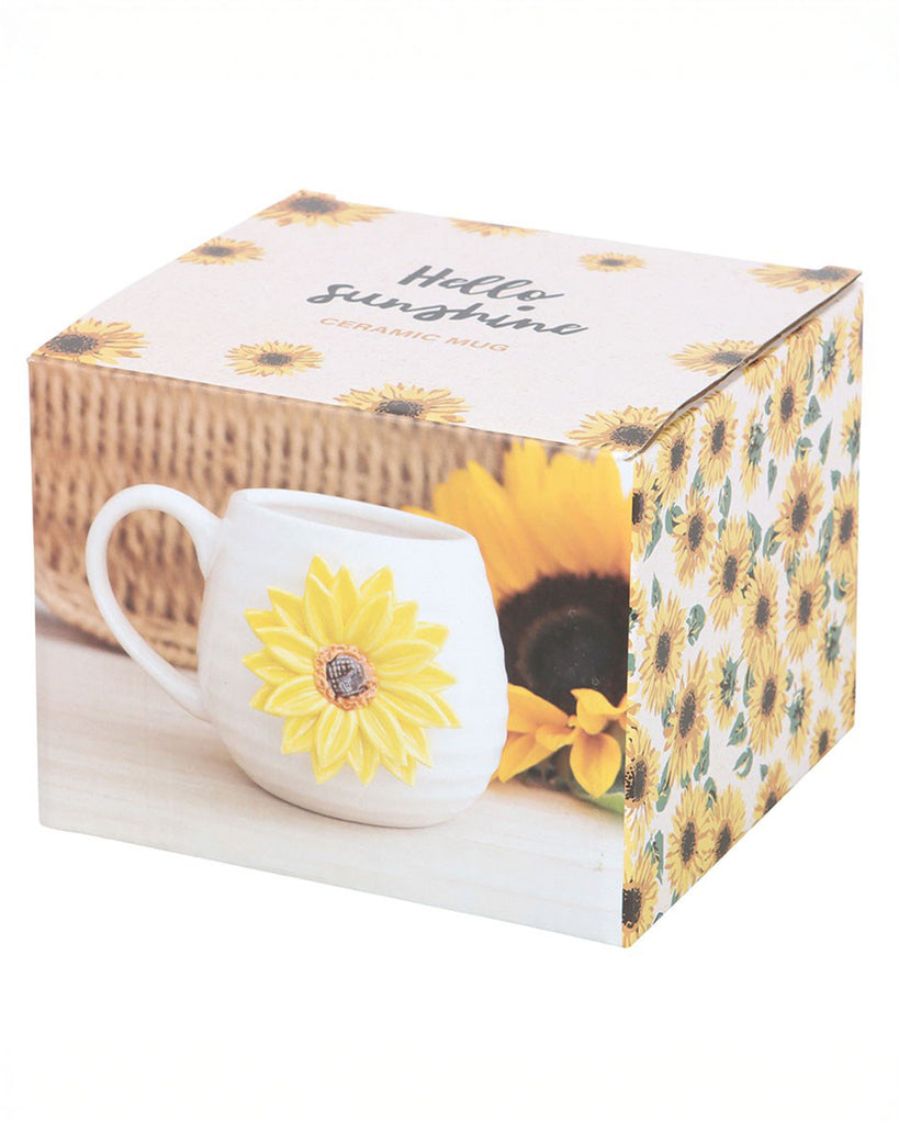 Rebel Romance Hello Sunshine ceramic mug in its decorative gift box featuring sunflower illustrations. The packaging shows the mug with its 3D sunflower design, ideal as a cheerful gift for homeware lovers.