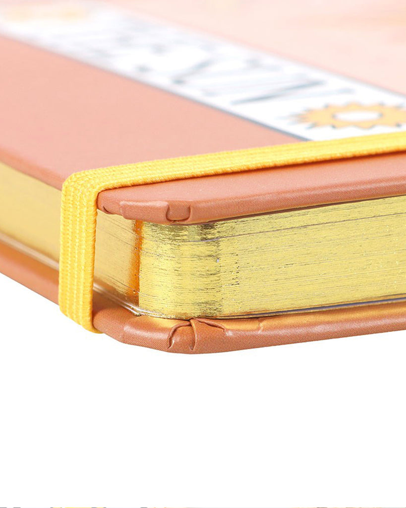 Close-up of Rebel Romance’s The Sun Vintage Tarot A5 Lined Notebook, showing the golden page edges, burnt orange cover, and yellow elastic strap. A stylish, alternative stationery item inspired by tarot cards, perfect for journalling or gifting. From a UK small business celebrating quirky and creative aesthetics for millennials.