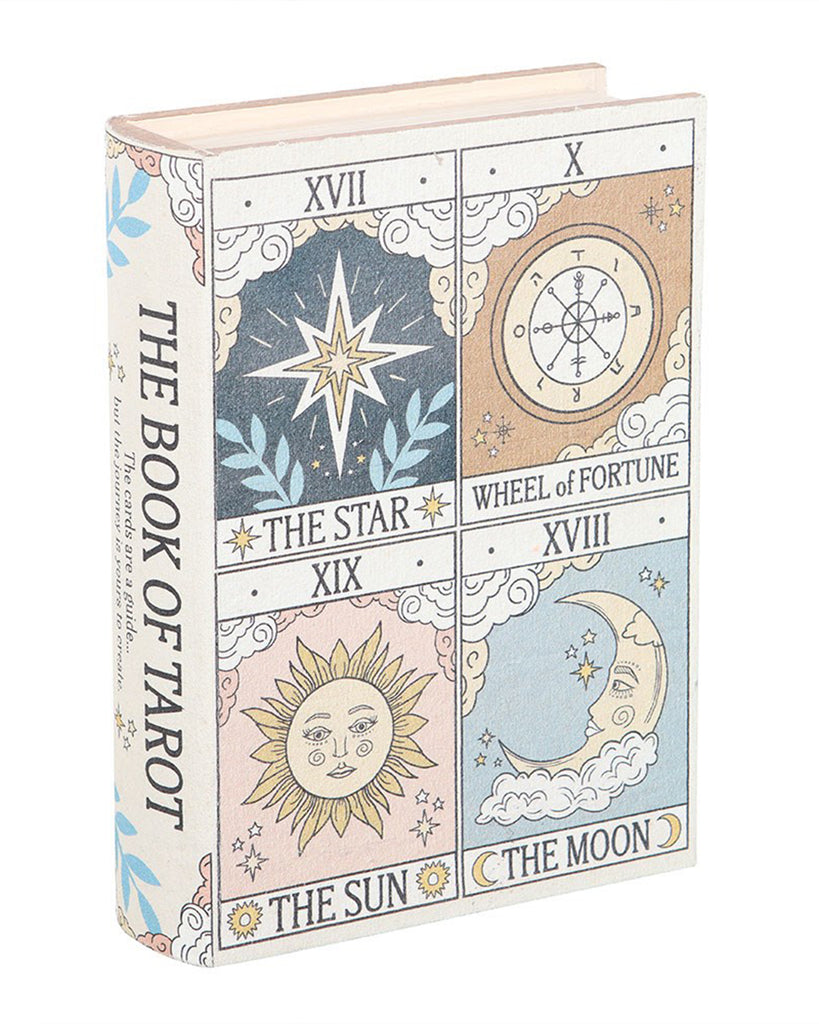 A front-facing view of a faux book storage box styled as "The Book of Tarot" with vintage illustrations of tarot cards: The Star, The Sun, The Moon, and The Wheel of Fortune. Stocked at Rebel Romance for magical storage with retro charm.