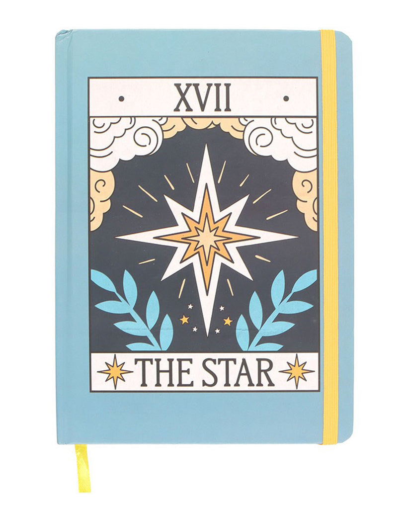 A pastel blue A5 notebook with a vintage-style ‘The Star’ tarot card cover design in orange, white, and blue with celestial symbols. Features a yellow elastic strap and matching ribbon marker.