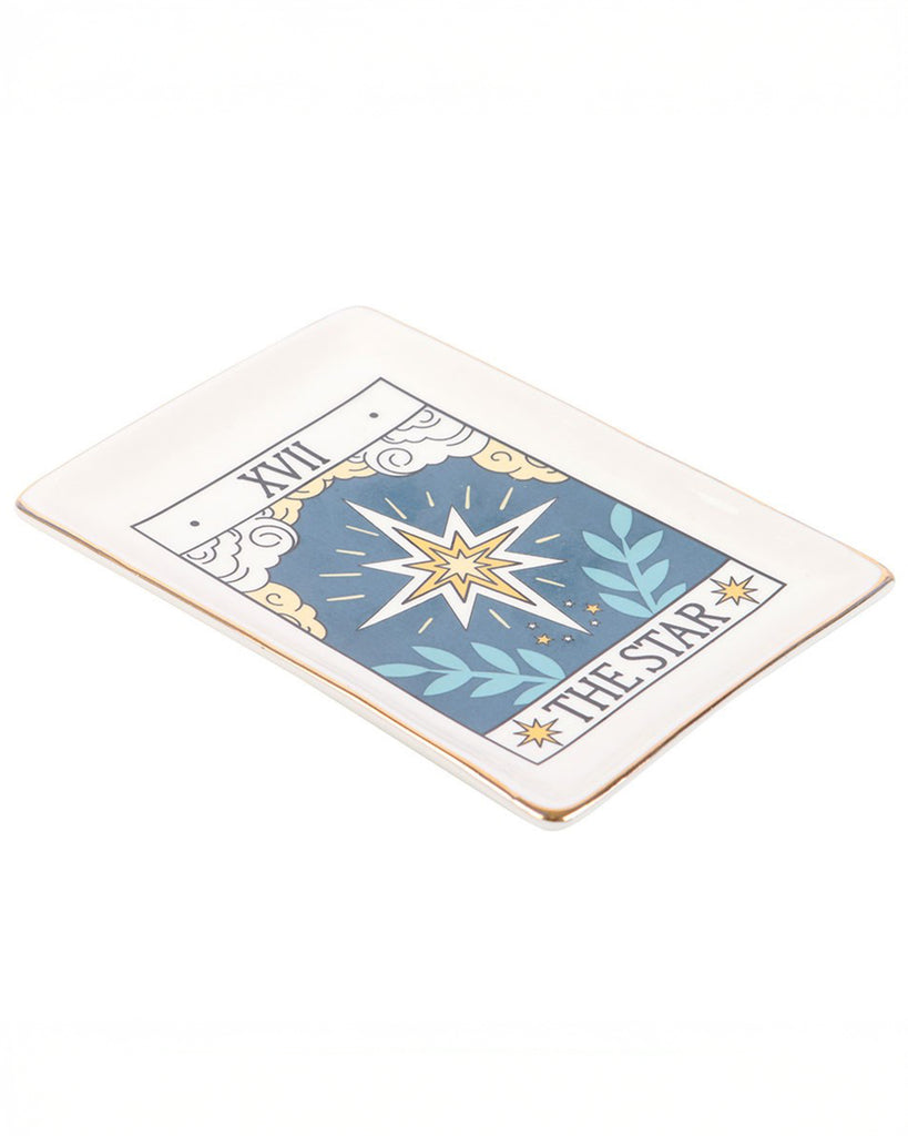 A close-up angled view of the Rebel Romance The Star tarot ceramic trinket dish with gold edging. The rectangular dish features a celestial star design in blue and gold, perfect for holding rings, necklaces or keys.