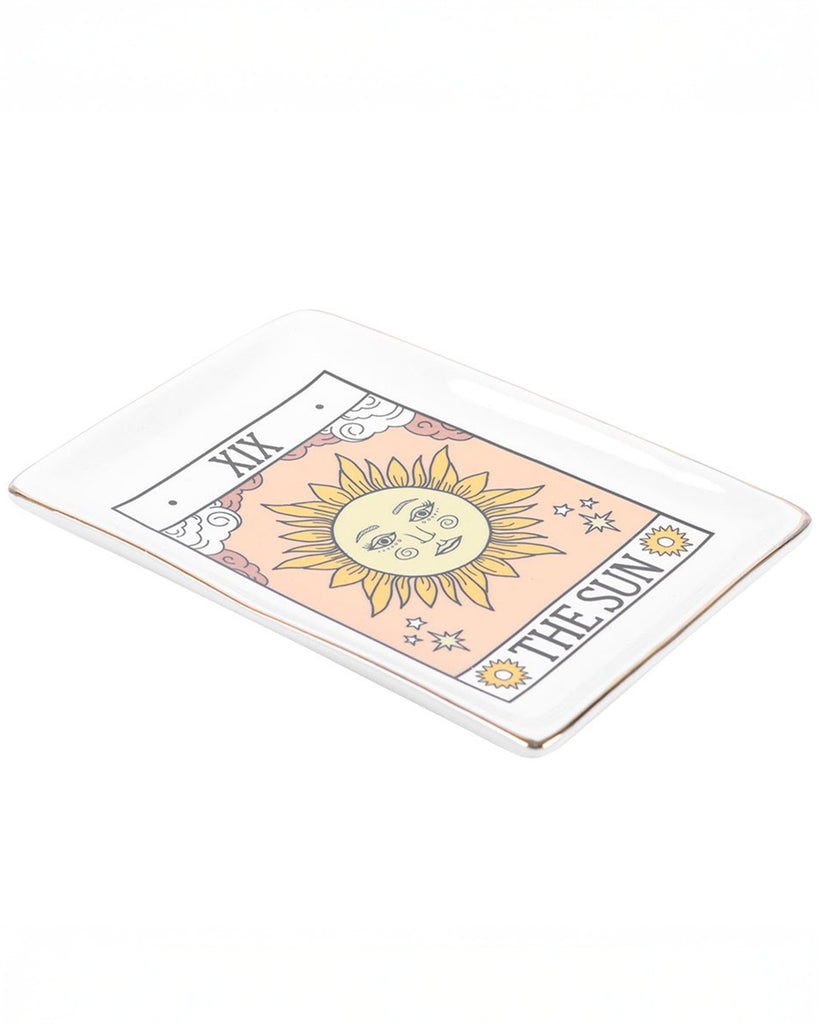 Close‑up angled view of The Sun tarot ceramic trinket dish by Rebel Romance. Features a bright sun illustration, soft peach tones, gold edging and mystical details, ideal for holding jewellery and tiny treasures.