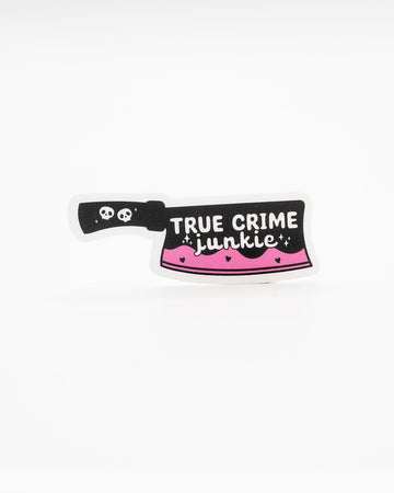 Edgy die-cut vinyl sticker shaped like a cleaver with a black handle and pink dripping blade. Features the phrase “True Crime Junkie” in white lettering, decorated with skulls, hearts, and sparkles. Perfect for fans of true crime and spooky aesthetics. Designed by Rebel Romance, a small UK brand known for alternative fashion, slow style, and quirky millennial-friendly gifts.