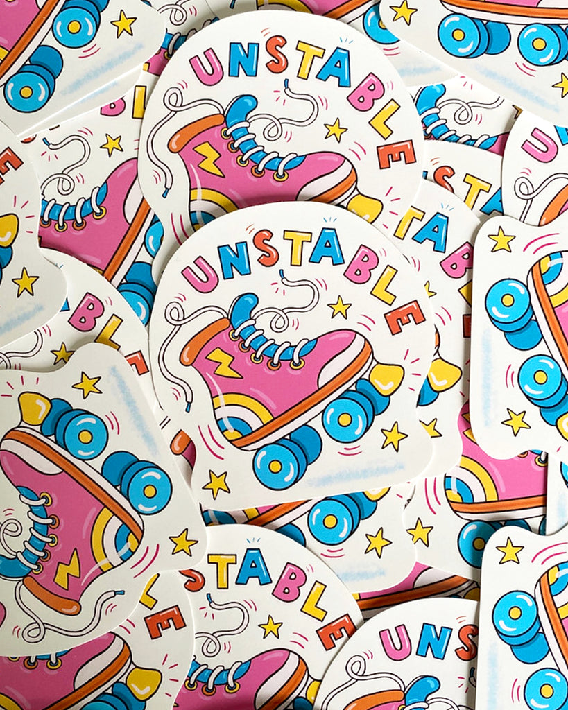 A pile of 'Unstable Rollerskate' glossy vinyl stickers, designed by Yasmin Cousins and stocked on Rebel Romance. Each sticker features a colourful pink retro roller skate with blue wheels and rainbow socks, surrounded by yellow stars and the word "UNSTABLE" in playful, multicoloured letters. Quirky and bold design with a fun, nostalgic aesthetic.