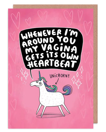  A sleazy looking white unicorn on a pink card with an arrow pointing to it saying 'UNICHORNY' Above that in a black speech bubble it says, 'Whenever I'm around you my vagina gets its own heartbeat.' It is on a pink card with hears and sparkles. Designed by Katie Abey