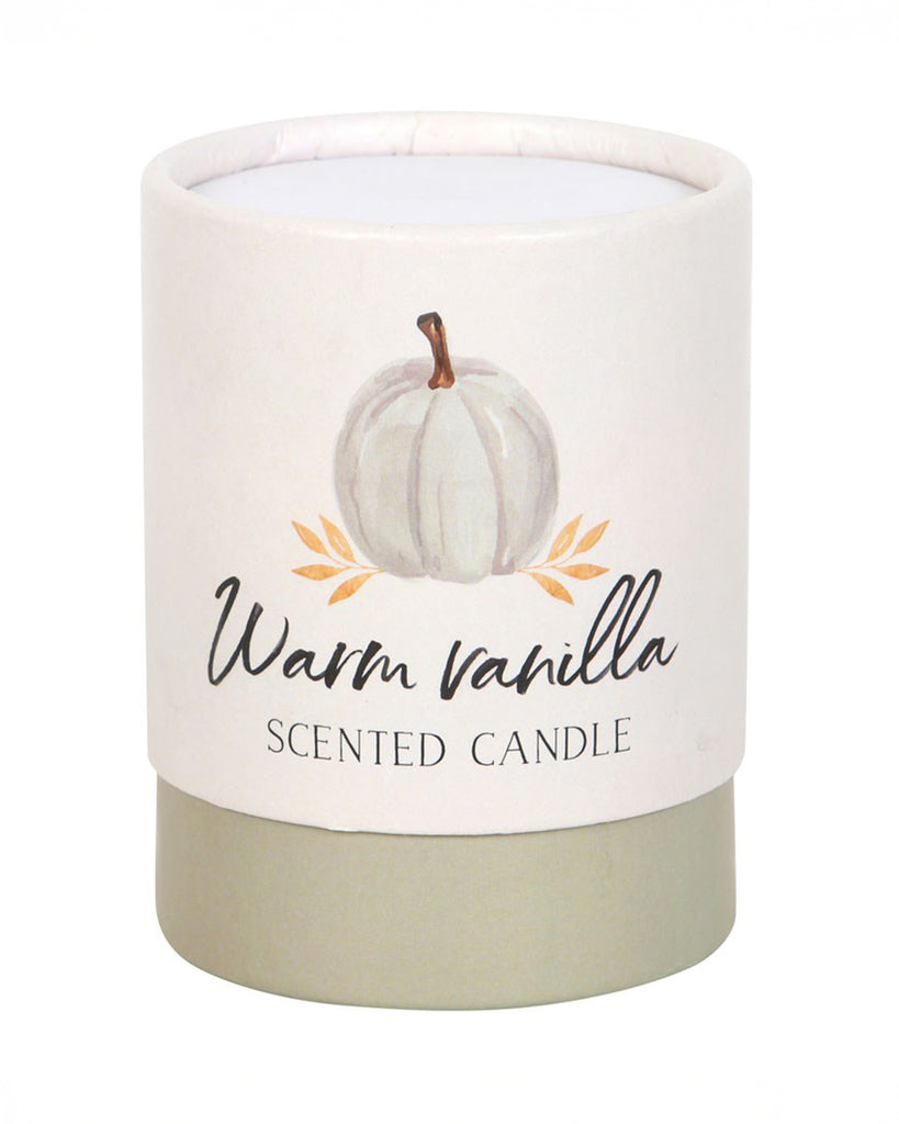 The Warm Vanilla candle in its cylindrical cardboard packaging, featuring a soft white pumpkin illustration and a neutral-toned base. Gift-ready and perfect for lovers of subtle, comforting fragrances.
