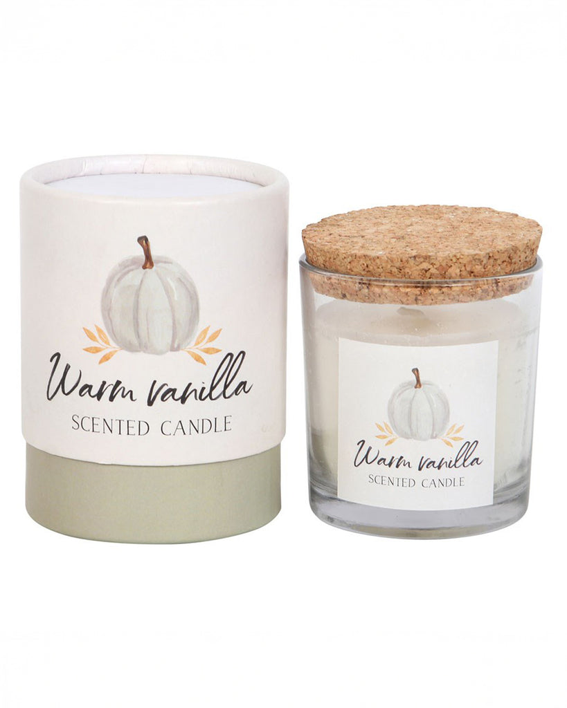 A styled shot of the Rebel Romance Warm Vanilla candle and its matching packaging, placed side by side. The combination of a glass jar, cork lid, and elegant design makes it a stunning seasonal gift.