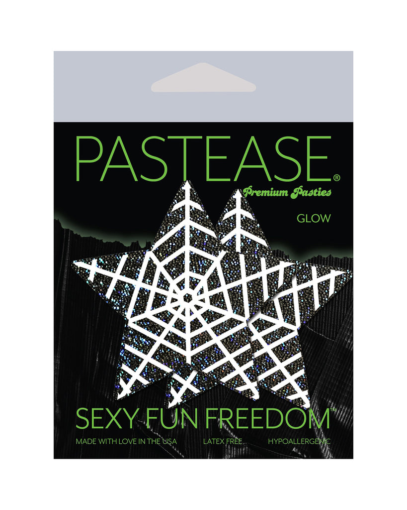 Star: Black Glitter Star with White Glow in the Dark Web Nipple Pasties by Pastease® o/s in the pastease glow black and green packaging. Perfect for a festival, pride, burlesque performance, only fans content or a party.