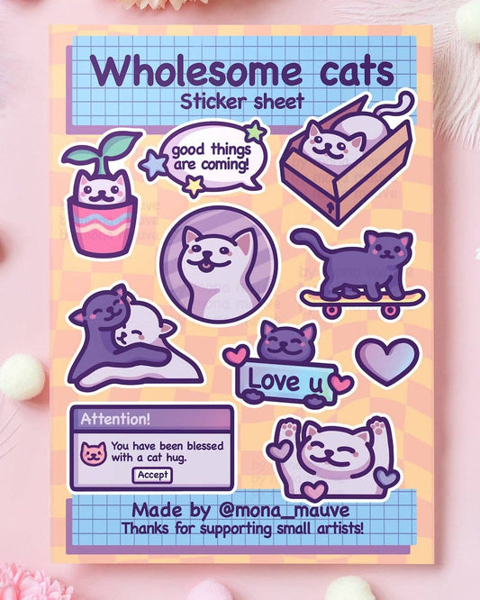 Wholesome Cats sticker sheet featuring 10 waterproof vinyl stickers with cute cat illustrations and uplifting messages like “Good things are coming!” and “Love u.” Includes hugging cats, a cat in a box, and an acceptance pop-up. Designed by Mona Mauve and sold by Rebel Romance, a small UK business celebrating queer joy, kindness, and alternative art.