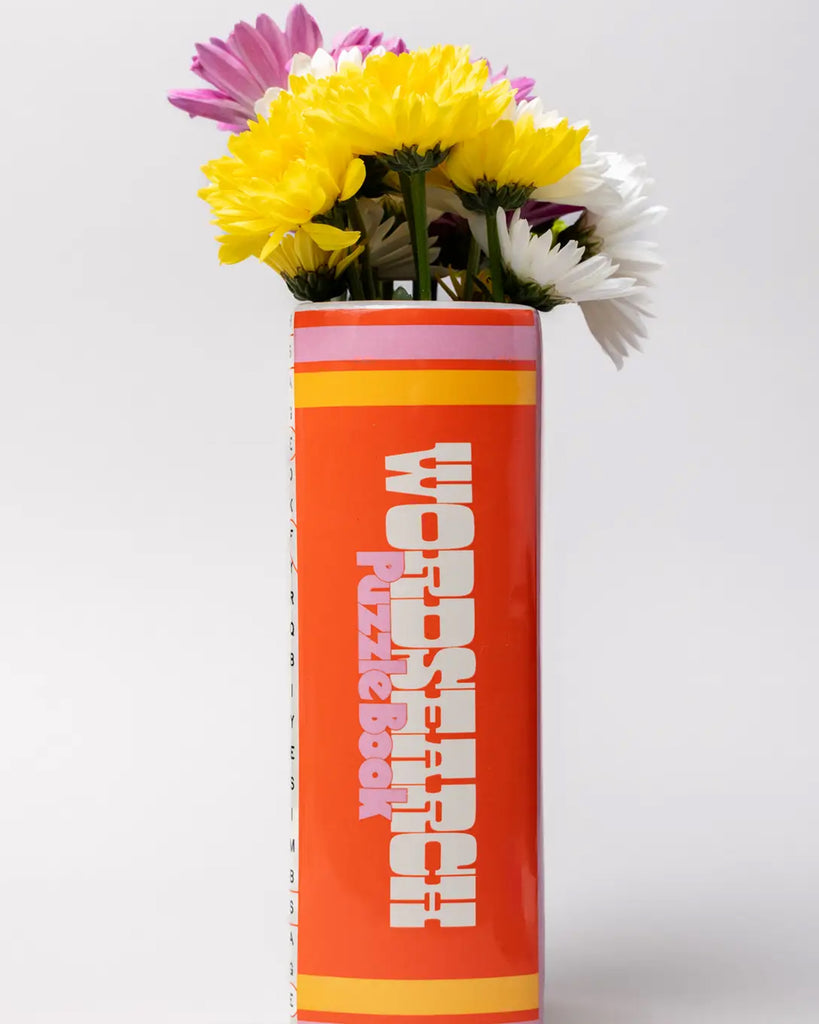 Spine view of the ceramic word search puzzle book vase with retro red and orange detailing, used as a flower holder by Rebel Romance.