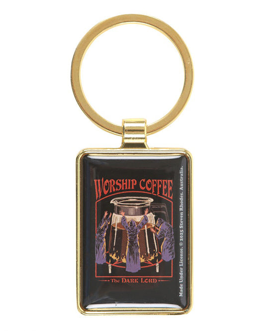 Front view of the Worship Coffee enamel keyring by Steven Rhodes, framed in gold metal. The design shows hooded figures worshipping a giant coffee pot with text above: “Worship Coffee – The Dark Lord.” Stocked by Rebel Romance, a UK alternative fashion and lifestyle store.