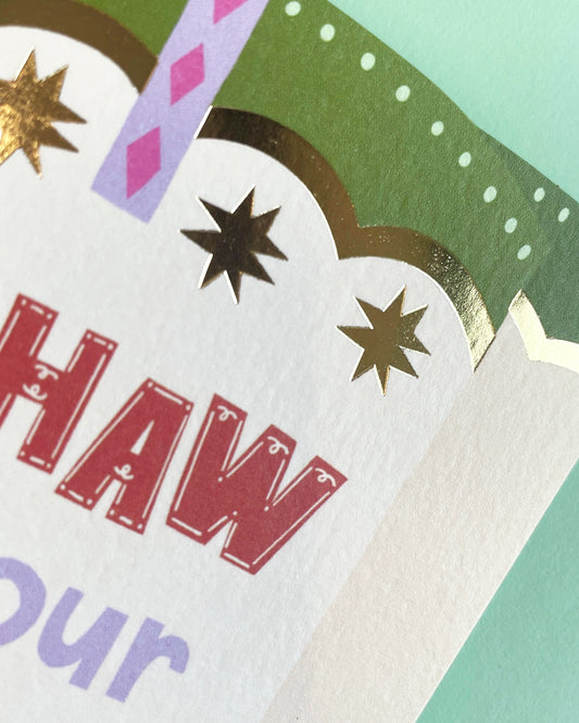 Yee-Haw It’s Your Birthday card from the Brightside collection featuring cowboy boots with red, blue, and green accents, bold Western lettering, and gold foil stars. Comes with a mint envelope, size 114 x 162mm.