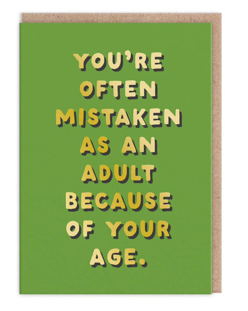 Funny green greeting card with bold yellow and white lettering reading You are often mistaken as an adult because of your age Comes with a brown kraft envelope A humorous and relatable card by Ohh Deer for birthdays friends and millennials who never feel like proper grown ups
