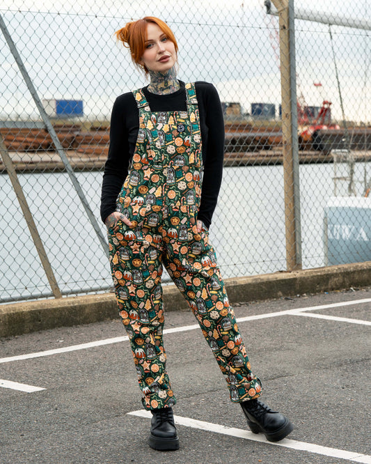 Rebel Romance Plum Mocha Boiler Suit shown on Erin with rolled cuffs and black platform boots. The zip-up jumpsuit features a collar and pockets, styled with tattoos on display for a bold alternative fashion look.